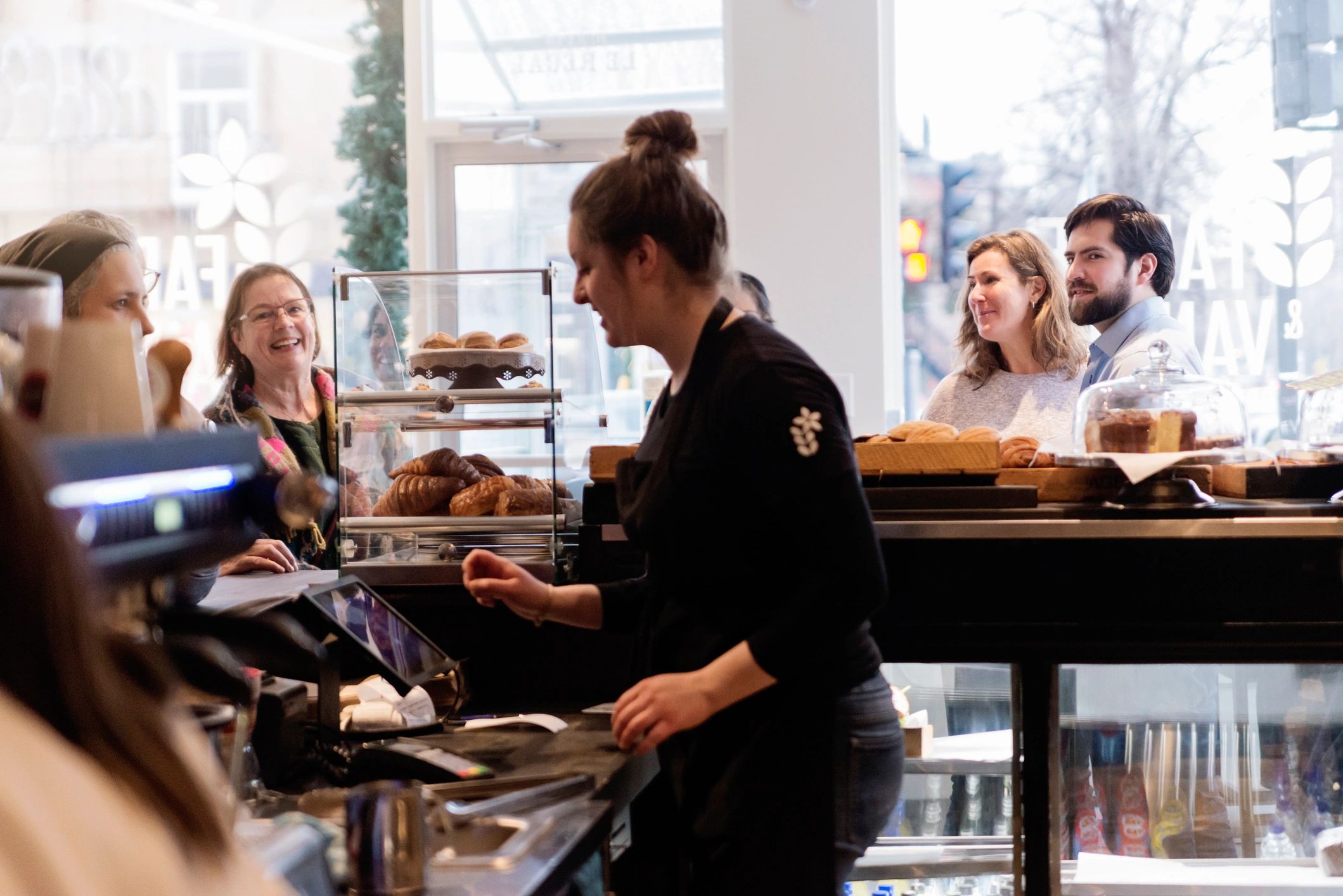 Bakery staff helping customers